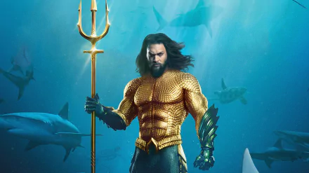 Jason Momoa as Aquaman in a dynamic 4K Ultra HD movie wallpaper, featuring the hero underwater with sharks in the background.