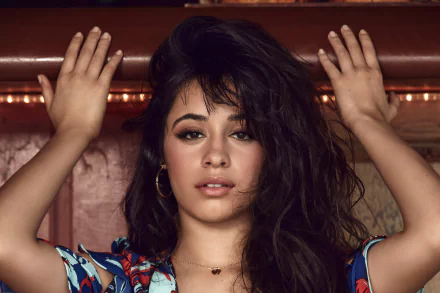 Close-up portrait of Latina singer Camila Cabello with brown eyes and brunette hair, wearing earrings, captured in vibrant 4K Ultra HD quality.