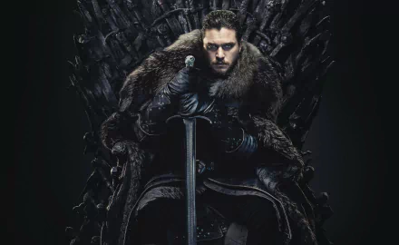 Kit Harington as Jon Snow from Game of Thrones sits on the Iron Throne, gripping a sword, set against a dark background in this HD desktop wallpaper.