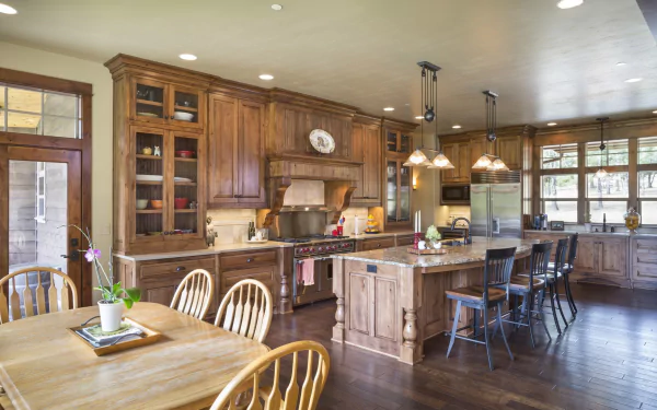 HD PC desktop wallpaper showcasing a spacious kitchen with wooden furniture, modern cabinetry, and a large island under warm lighting in a well-designed room.