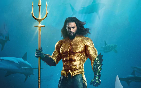 Jason Momoa as Aquaman in a dynamic 4K Ultra HD movie wallpaper, featuring the hero underwater with sharks in the background.