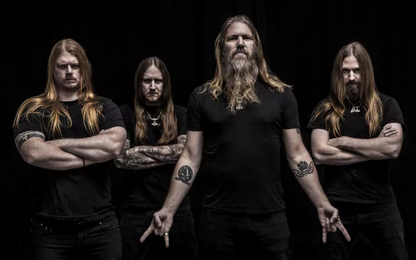 Amon Amarth band members posing against a black background, featured in a 4K Ultra HD music-themed PC desktop wallpaper.