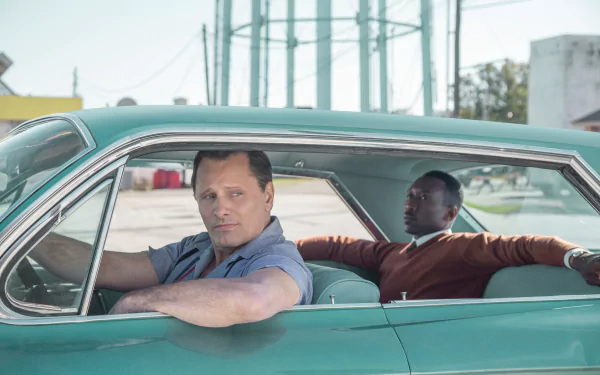 HD desktop wallpaper featuring two characters from the movie Green Book sitting in a vintage car.