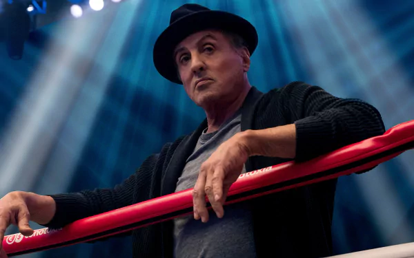 Sylvester Stallone as Rocky Balboa in Creed II, posing in a boxing ring, for a HD desktop wallpaper.