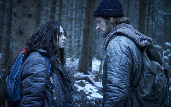 HD desktop wallpaper featuring characters from Hanna, including Esme Creed Miles, set in a snowy forest background.