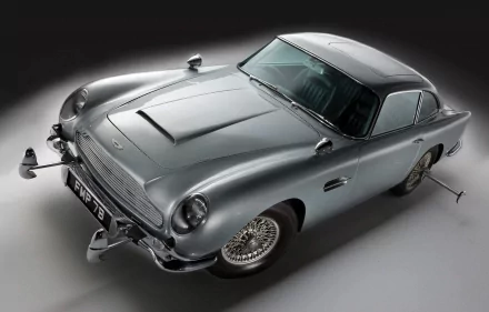 A sleek Aston Martin DB5, a classic movie vehicle, showcased in high-definition as a desktop wallpaper or background, featuring its iconic design and polished silver exterior.