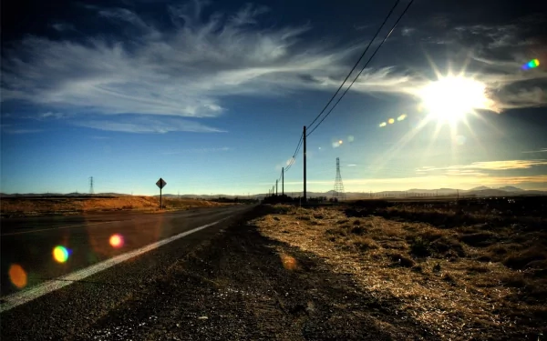 HD desktop wallpaper featuring a man-made road stretching toward a harbor under a bright sun and dramatic sky.
