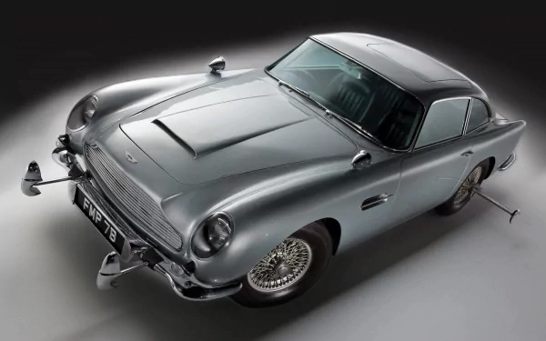 A sleek Aston Martin DB5, a classic movie vehicle, showcased in high-definition as a desktop wallpaper or background, featuring its iconic design and polished silver exterior.