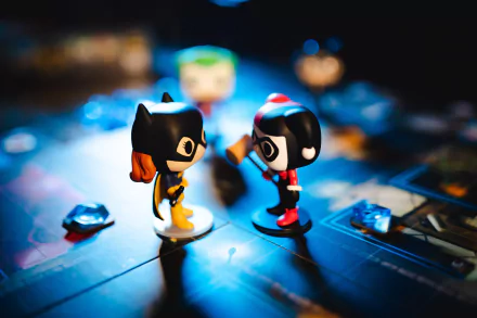 Batgirl and Harley Quinn Funko POP! figures face off on a Funkoverse Strategy Game: DC Comics 100 board — 5K Ultra HD PC desktop wallpaper showcasing man-made collectible toys.