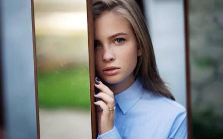 HD PC desktop wallpaper: close-up of a blonde woman model's face framed by narrow panels, wearing a blue shirt with a soft blurred green background.