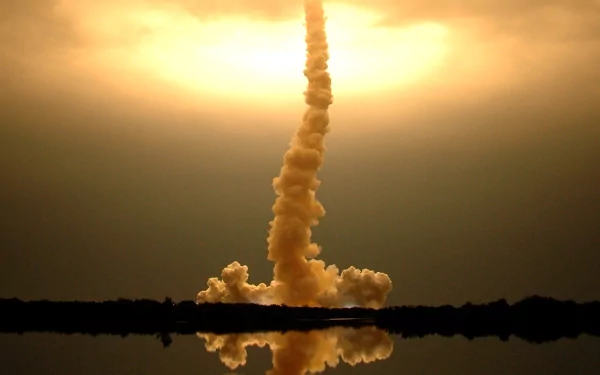A man-made NASA rocket launch captured at sunset, with smoke and flame reflected in the water below, featured as an HD PC desktop wallpaper and background.
