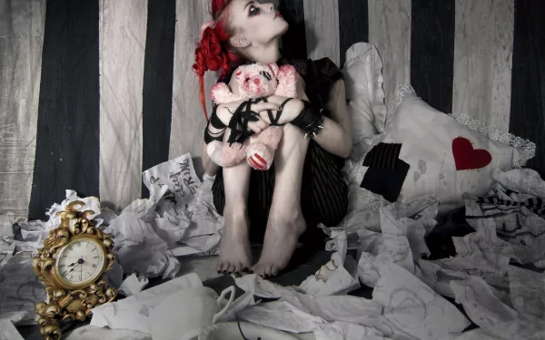 HD PC desktop wallpaper featuring Emilie Autumn in a dark, theatrical setting with torn papers, a vintage clock, and striped backdrop, capturing her music persona.