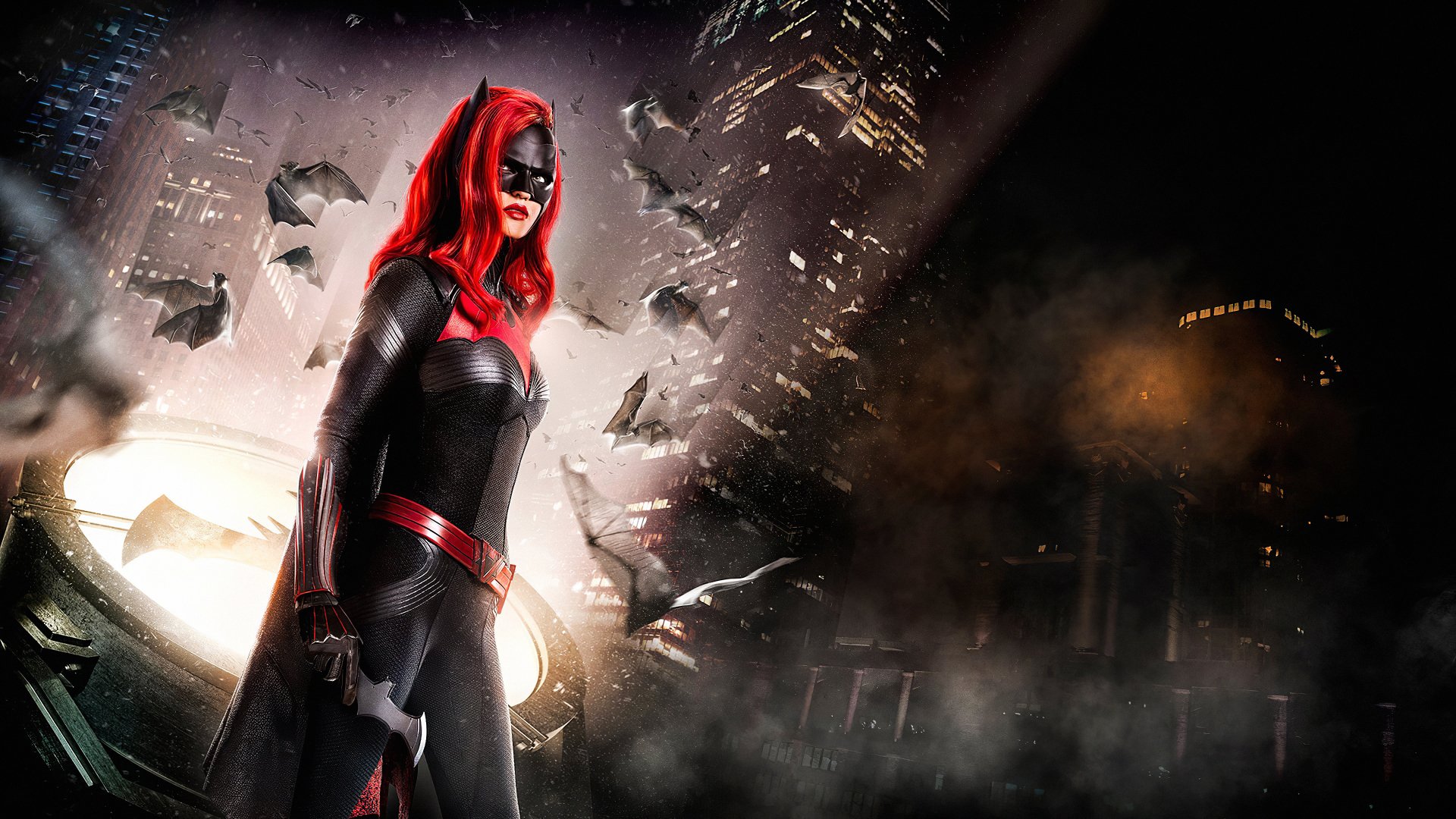 4K desktop wallpaper of Batwoman (Kate Kane) from the DC Comics TV show — red-haired, masked heroine in a black suit standing against a smoky, bat-filled Gotham skyline.