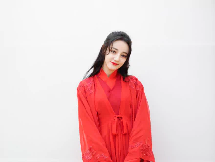 HD desktop wallpaper of Chinese actress and celebrity Dilraba Dilmurat with black hair and red lipstick, dressed in a vibrant red outfit against a plain white background.