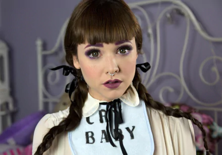 HD PC desktop wallpaper featuring American singer Melanie Martinez with braided hair, bold lipstick, and a vintage-inspired outfit.