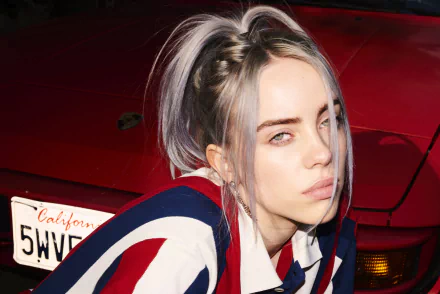 Close-up 4K Ultra HD image of American singer Billie Eilish with platinum hair, against a red car backdrop, suitable as a PC desktop wallpaper.
