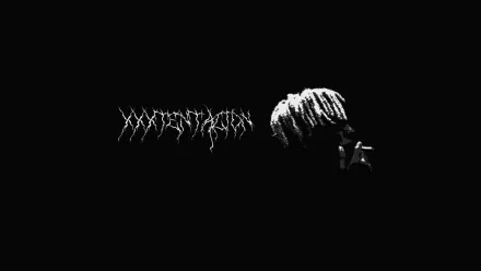 HD PC desktop wallpaper featuring a dark, minimalist design with the name and silhouette of singer XXXTentacion against a black background.