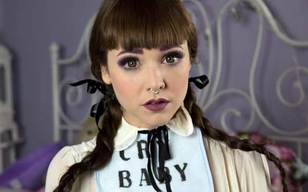 HD PC desktop wallpaper featuring American singer Melanie Martinez with braided hair, bold lipstick, and a vintage-inspired outfit.