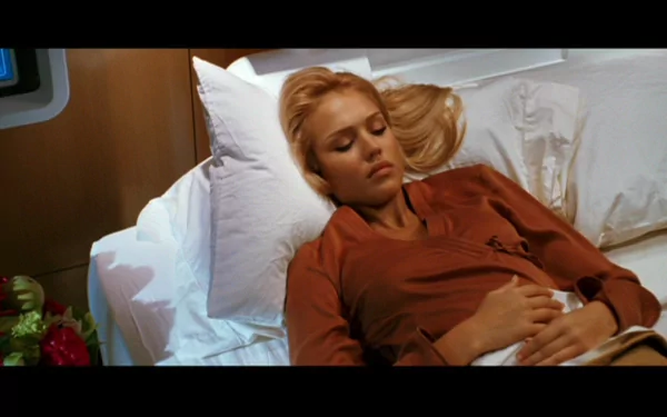 A cinematic HD desktop wallpaper featuring a serene scene from the movie Fantastic Four, depicting a woman resting comfortably on a bed.