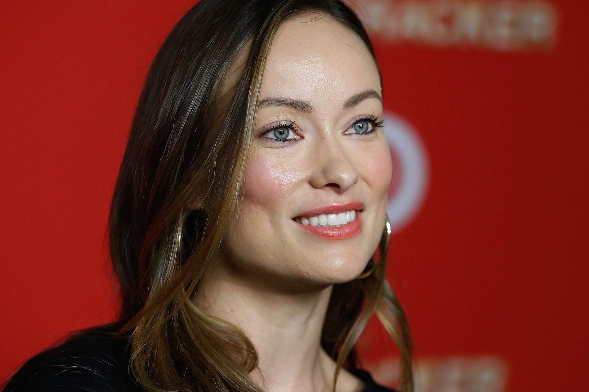 Close-up portrait of a smiling American brunette celebrity actress with blue eyes, face framed by hair — 2K Quad HD PC desktop wallpaper/background.
