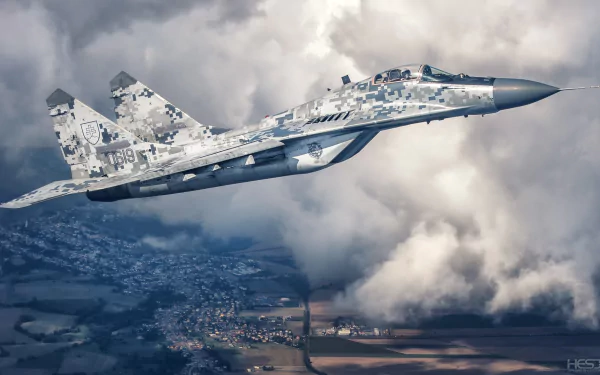 HD PC desktop wallpaper of a Mikoyan MiG-29 military jet fighter aircraft in digital camouflage slicing through clouds above a patchwork landscape