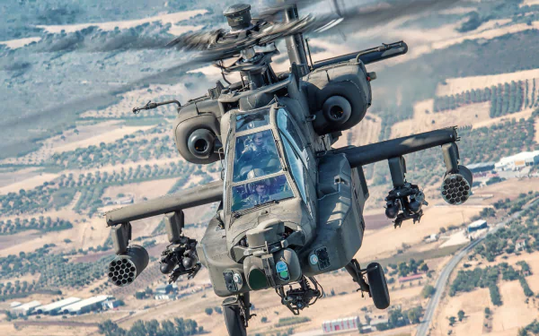 HD desktop wallpaper featuring a Boeing AH-64 Apache attack helicopter in flight over a desert landscape, showcasing its military design and armament.