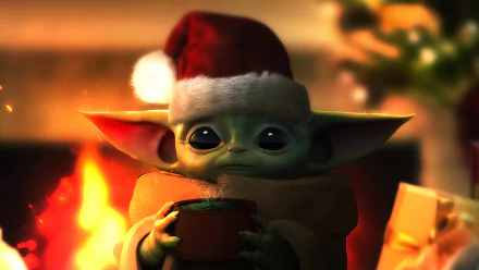 Grogu from The Mandalorian wearing a Santa hat, holding a cup by a cozy fire, featured in a 4K Ultra HD Star Wars desktop wallpaper.