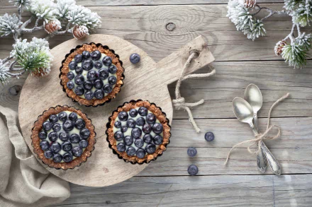  Blueberry Cream Tarts on a Wooden Board