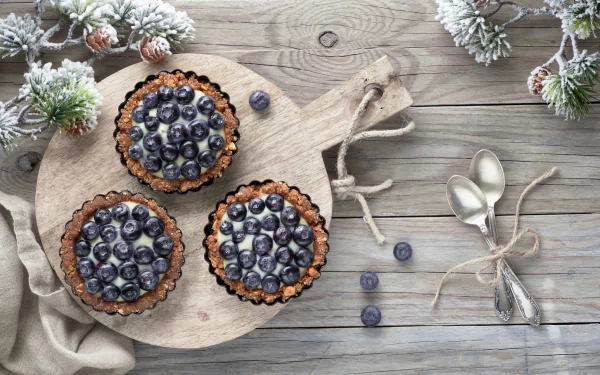  Blueberry Cream Tarts on a Wooden Board