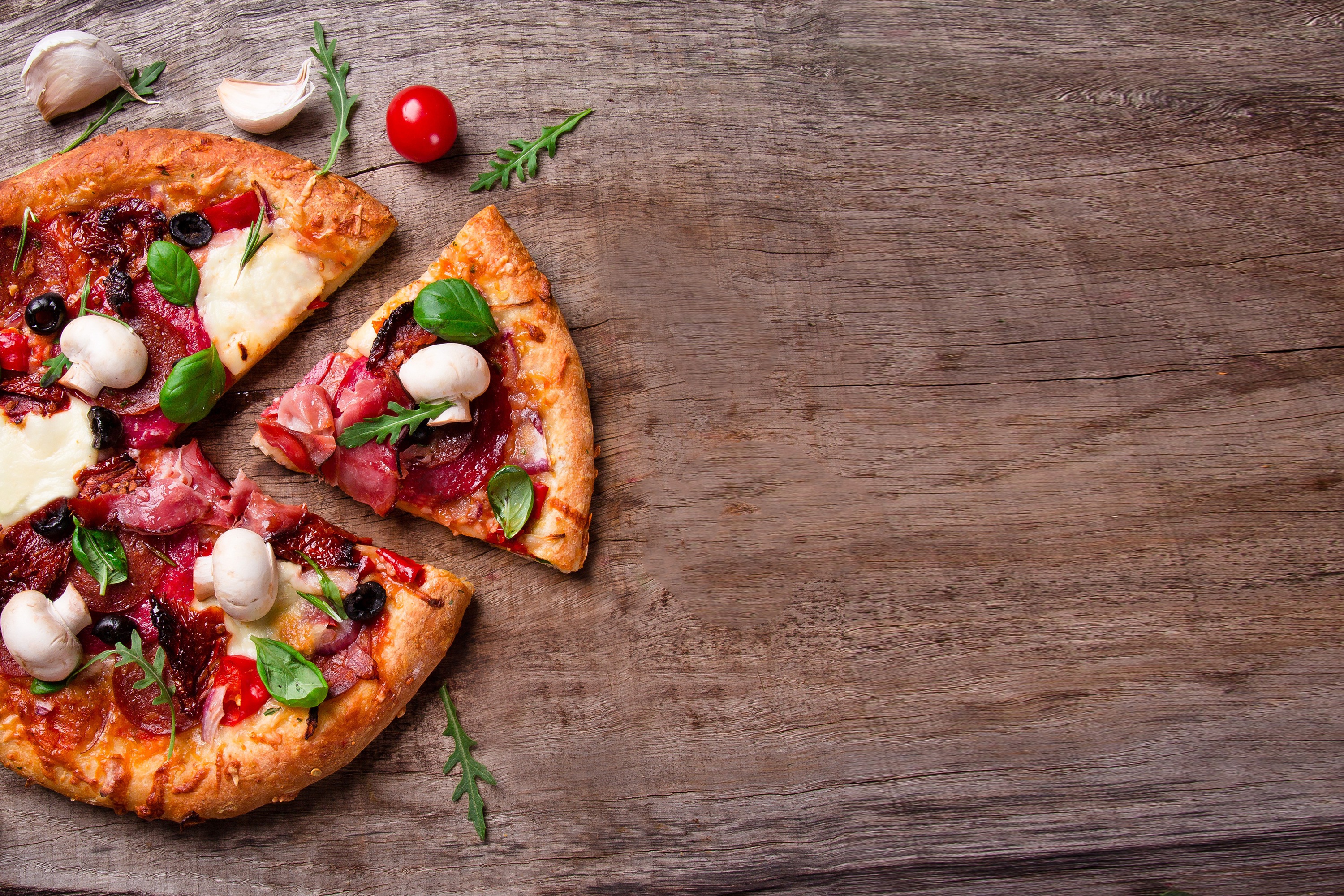Pizza with Mushrooms, Olives and Meat on a Wooden Board by Bruno Marques Bru