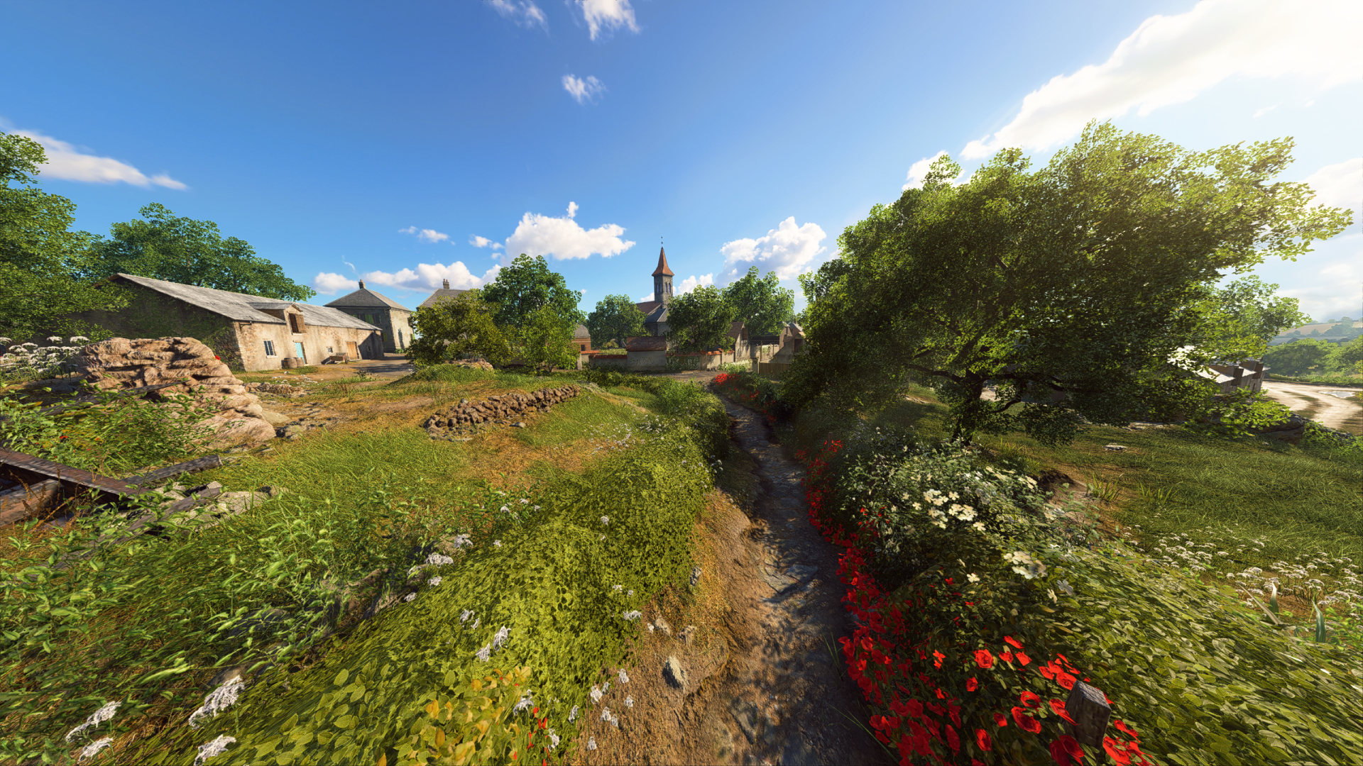 Bright 2K Quad HD PC desktop wallpaper: Battlefield V video game countryside with lush vegetation, poppies by a stream, stone cottages and a distant church under a blue sky.