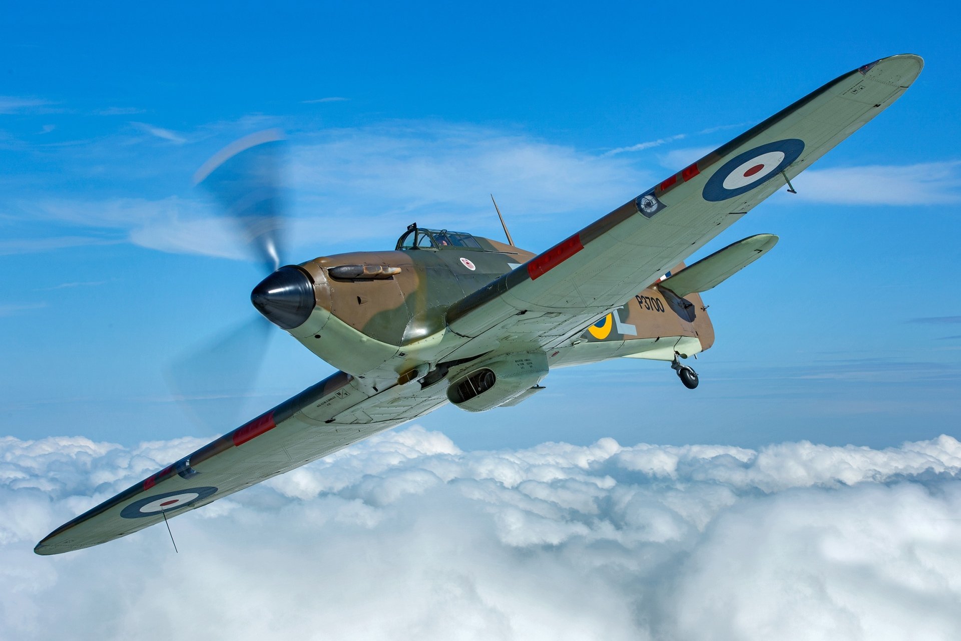 Hawker Hurricane military aircraft and warplane in flight above clouds, propeller blur against blue sky — HD PC desktop wallpaper and background.
