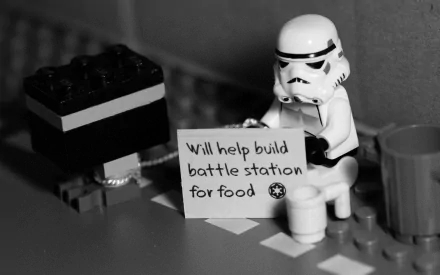 Sci-Fi HD desktop wallpaper of a LEGO Star Wars Stormtrooper holding a humorous sign that reads, Will help build battle station for food.