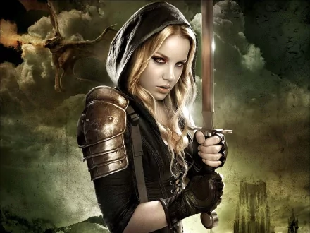 Abbie Cornish as Sweet Pea from *Sucker Punch*, wearing armor and a hood, holds a sword against a dramatic, moody background. High-definition desktop wallpaper featuring a cinematic style.