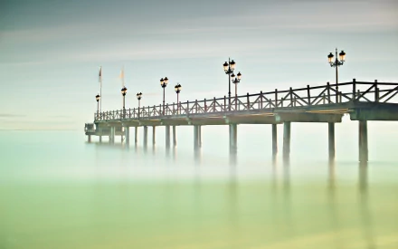A serene man-made pier extends over calm waters in Andalusia, Spain, captured in this HD desktop wallpaper and background image.