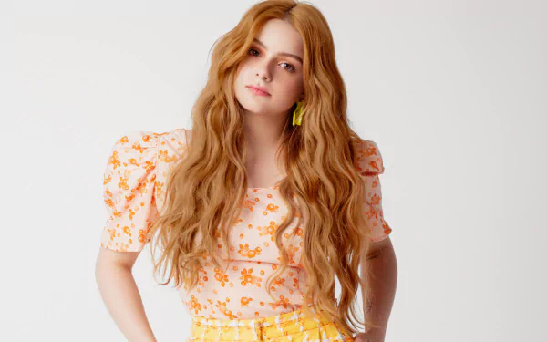 Ariel Winter, American actress with long red hair and brown eyes, poses confidently against a plain white background in this HD desktop wallpaper.