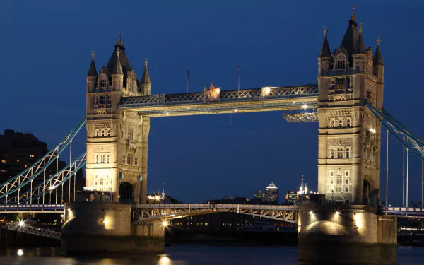 Illuminated Tower Bridge in London at night over the Thames — a man-made landmark rendered in 4K Ultra HD for PC desktop wallpaper and background.