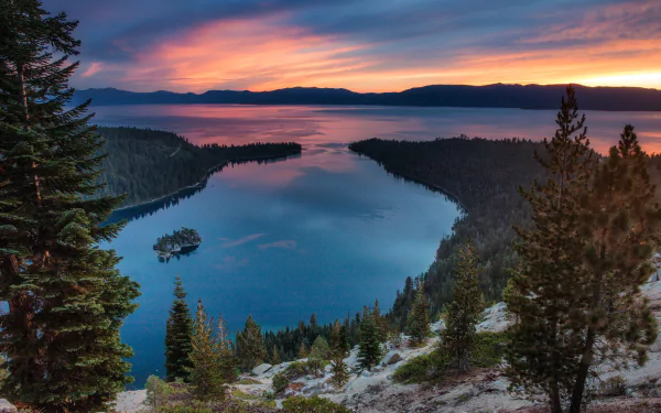 A stunning 4K Ultra HD view of Tahoe Lake at sunset, nestled in the Sierra Nevada, USA, showcasing vibrant skies and serene natural landscape.