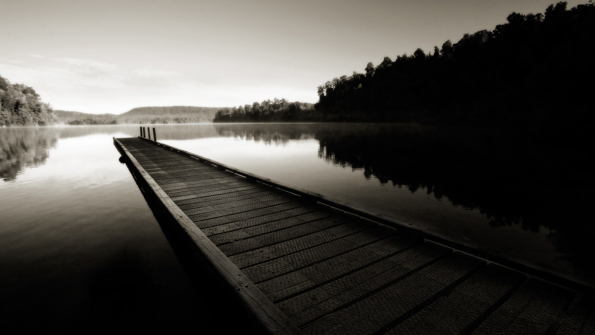 Black and white photography of a pier on a desktop wallpaper.