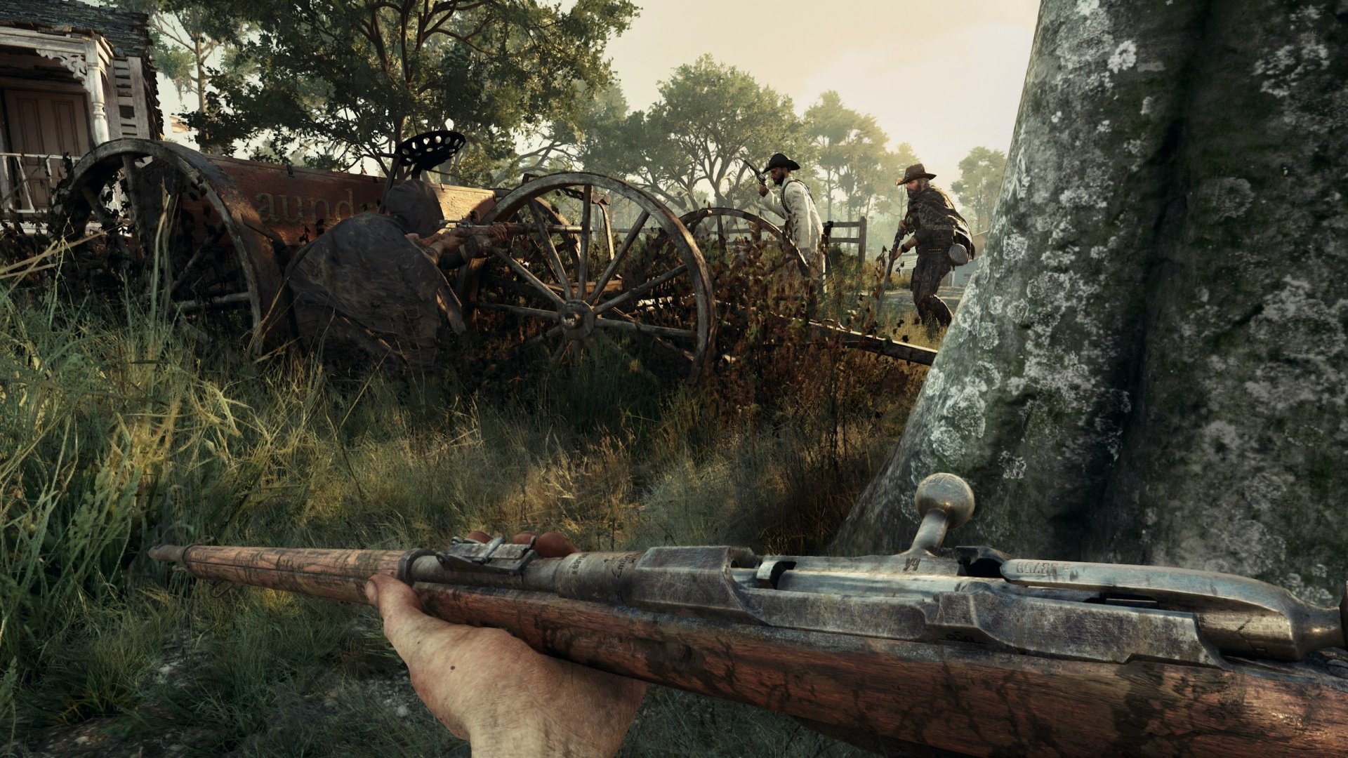 HD wallpaper from Hunt: Showdown featuring a first-person view of a hunter with a rifle, companions ahead, by an old cannon and wagon.