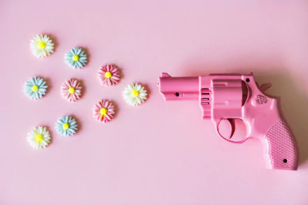  Small Pink Revolver Shooting Flowers by rawpixel