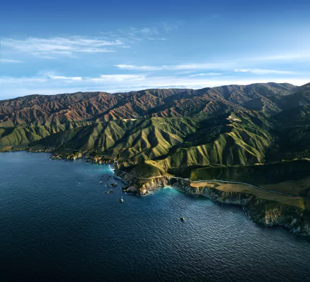 Aerial view of Big Sur coastline and mountains along the ocean, captured in a 4K Ultra HD landscape wallpaper background by Apple Inc.