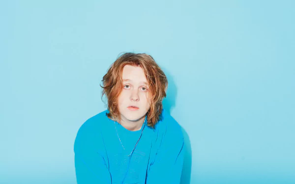 HD wallpaper featuring a person in a blue sweater against a matching blue background.