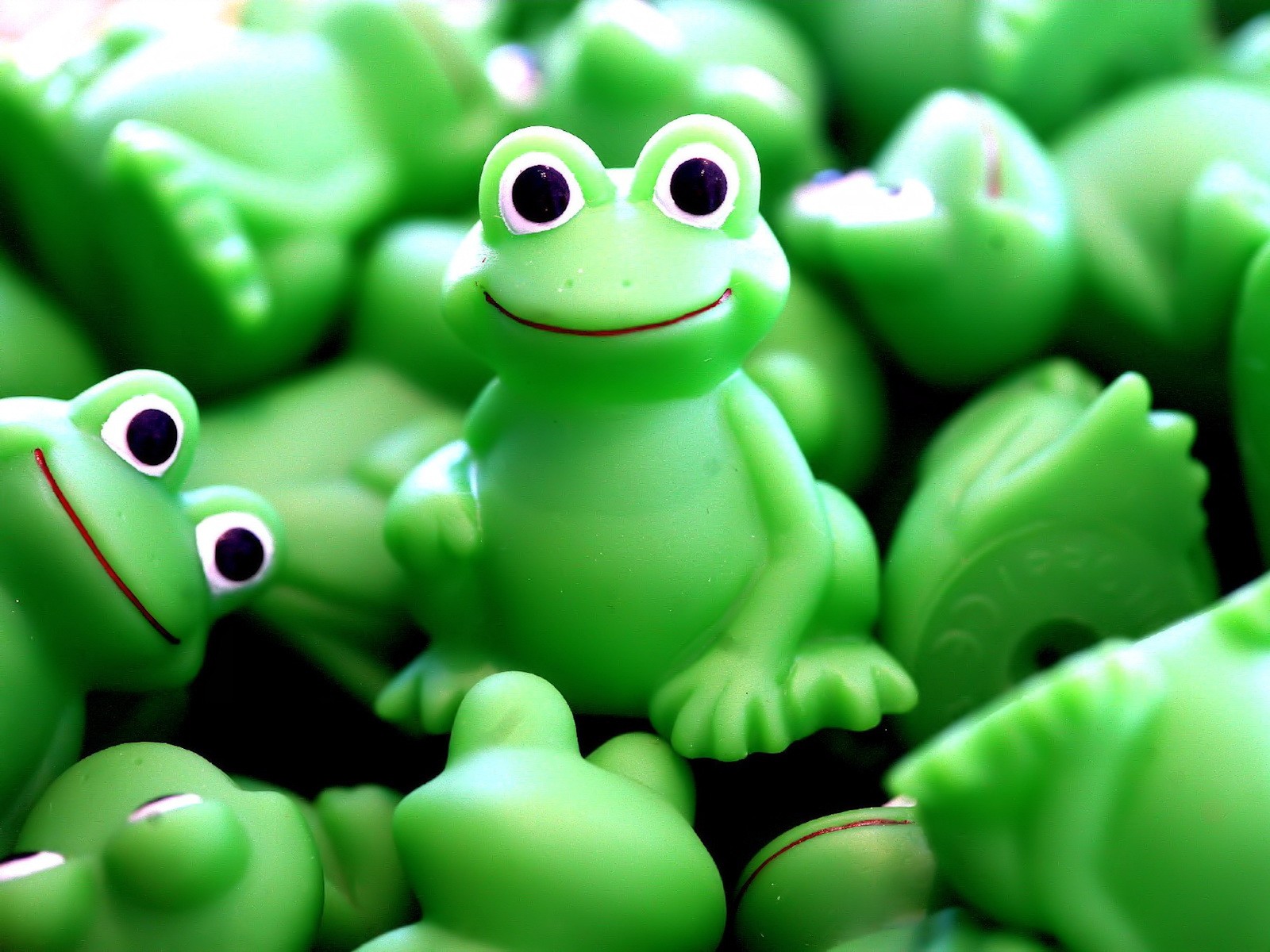 Desktop wallpaper named Toy | Green Frogs featuring a man-made toy with green frogs on it.