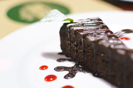  Chocolate cake in a restaurant by Jakub Kapusnak