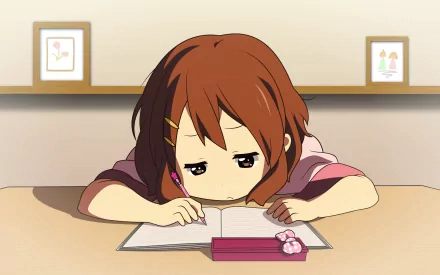 Yui Hirasawa from the anime K-ON! appears focused on her studies, resting her head on an open notebook. A cozy room setting enhances this HD PC desktop wallpaper.