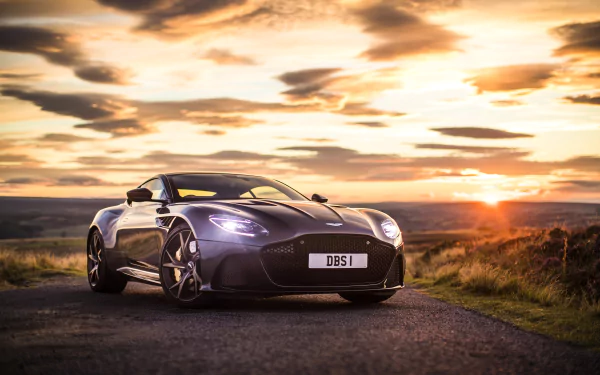 Purple Aston Martin DBS Superleggera parked on a road at sunset, captured in 4K Ultra HD as a PC desktop wallpaper and background.