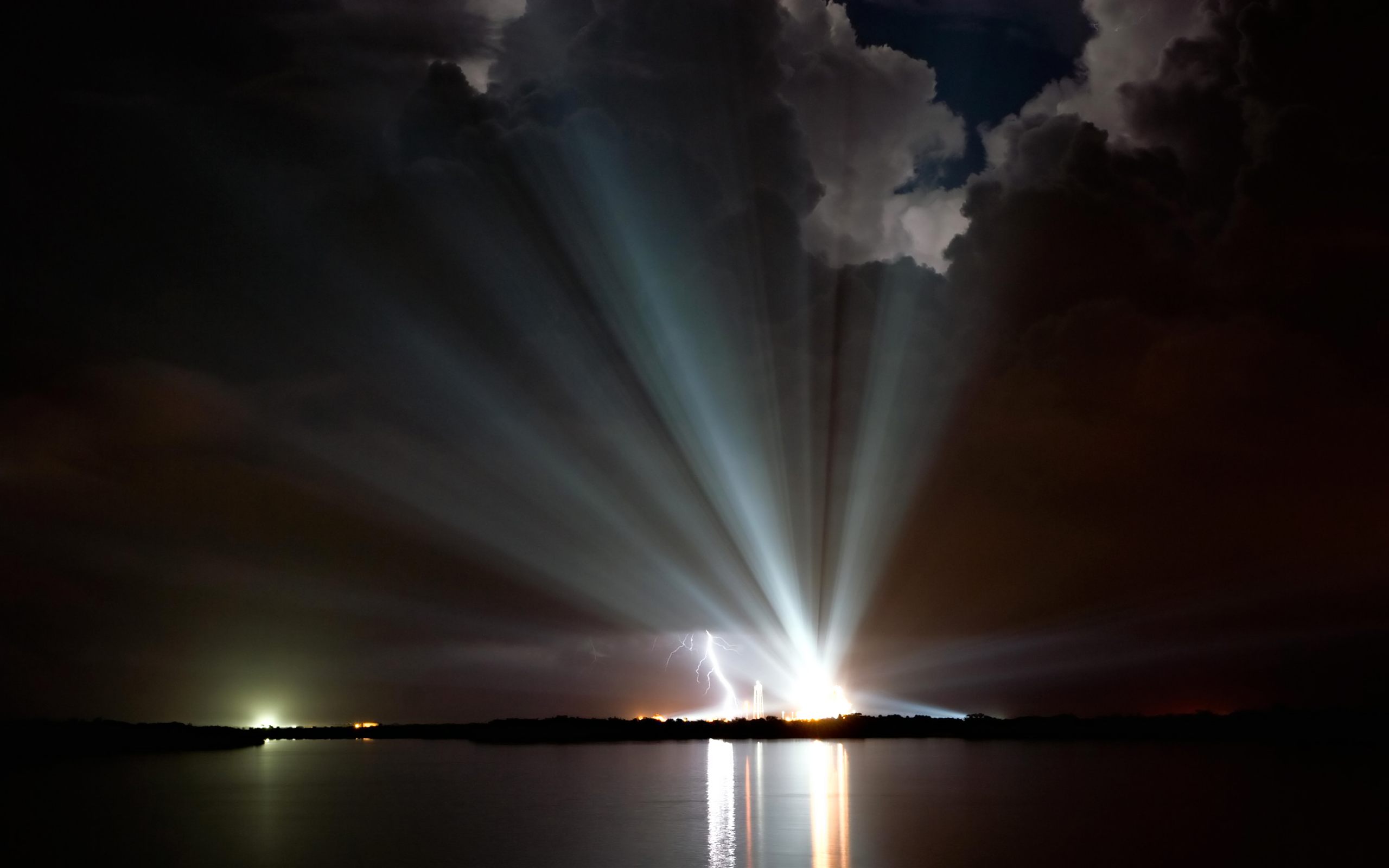 NASA's Space Shuttle Discovery radiates stunning lights against a dark backdrop, showcasing man-made brilliance.