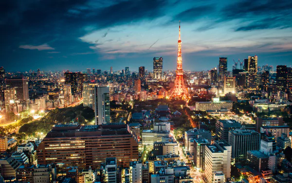 HD PC desktop wallpaper: night cityscape of Tokyo, Japan with illuminated Tokyo Tower rising amid a man-made skyline and glowing urban lights under a dramatic sky.