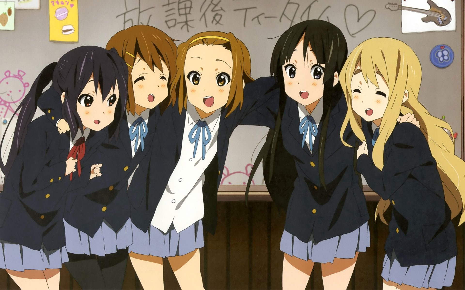 HD anime desktop wallpaper featuring the main characters from K-ON! in school uniforms posing cheerfully in a classroom setting.